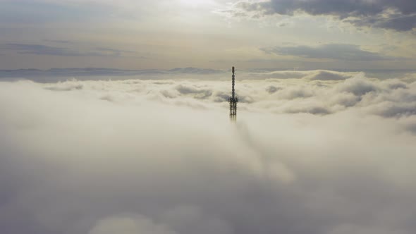 Aerial View of the Upper Part of the Broadcasting Tower in the Fog alt