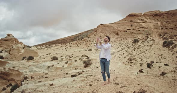 Young Tourist Man Walking Through the Rocks and alt