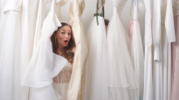 Two Caucasian Girlfriends Among Wedding Dresses alt