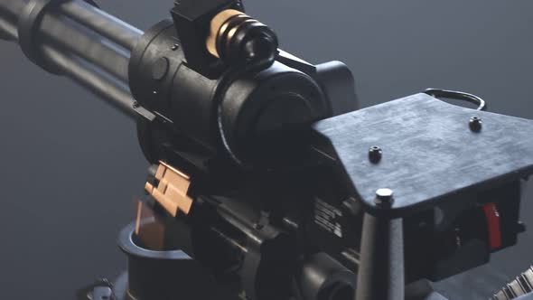 Minigun firing to the invisible target. Deadly firearm rapidly shooting bullets. alt