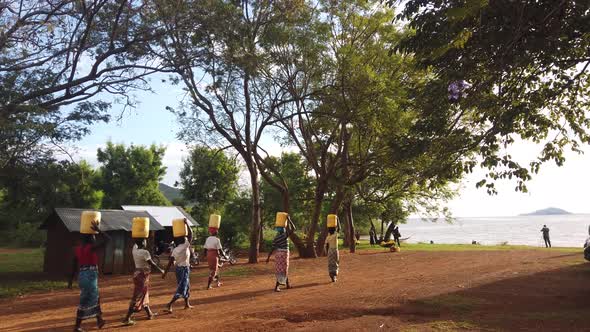 African Women Transporting Water Bottles alt