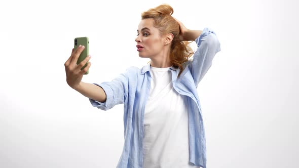Smiling Woman Touch Her Hair in Front of Mobile Phone Camera Selfie Video alt
