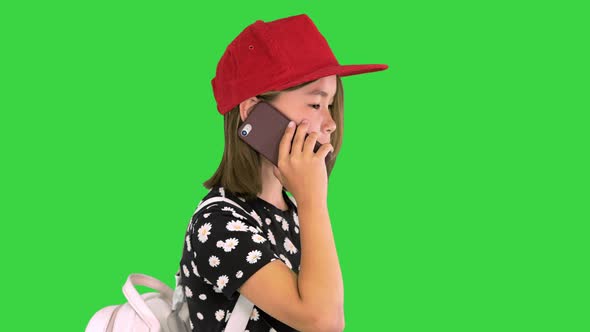 Young Asian Girl Talking on Smart Phone on a Green Screen Chroma Key alt