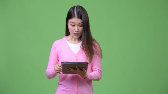 Young Beautiful Asian Woman Using Digital Tablet