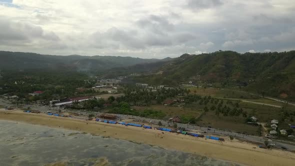 Makeshift tents of a refugee camp on beachPerfect aerial view flight panorama overview drone footag alt