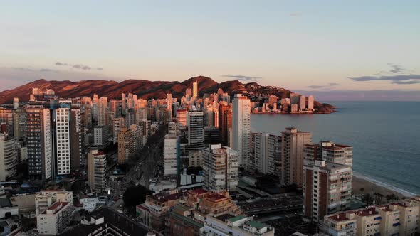 Aerial footage of Benidorm at sunset showing the beaches