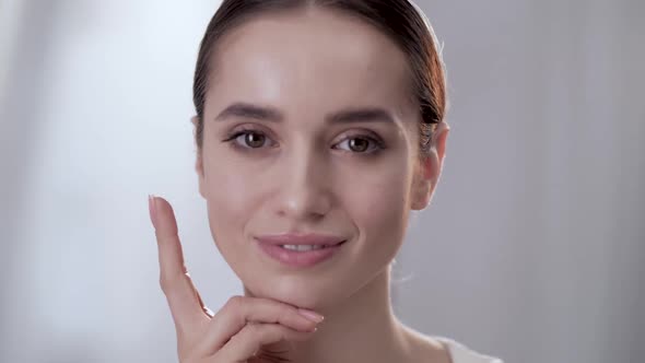 Healthy Face Skin. Beautiful Woman Touching Beauty Face alt