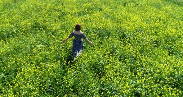 Top View of Woman Walking Through a Wild Meadow