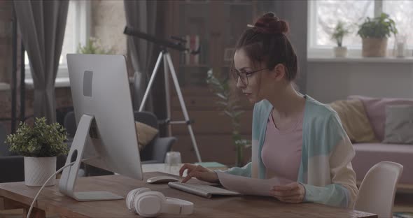 Young Woman Working Hard At Home With Computer