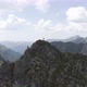 Man Standing on top of a Cliff in Rocky Mountains - VideoHive Item for Sale