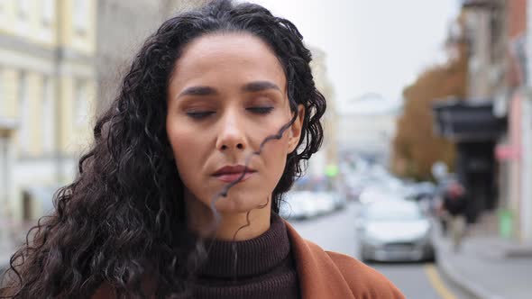 Closeup Pensive Serious Sad Millennial Girl 30s Woman Brunette Hispanic Lady Female with Long Curly alt