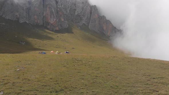 Aerial Shot of a Camp of Climbers in the Mountains Among the Clouds.