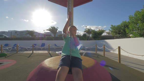 Child on flying fox at the playground alt