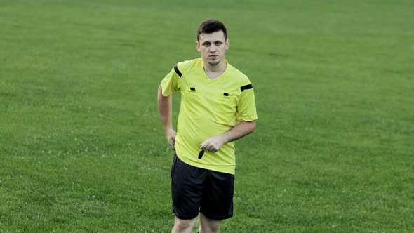 Soccer referee showing red card and removes player . Concept of sport, rules violation, offside. alt