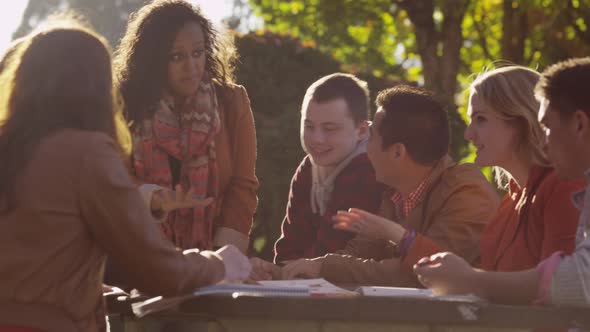 Group of college students on campus meeting outdoors