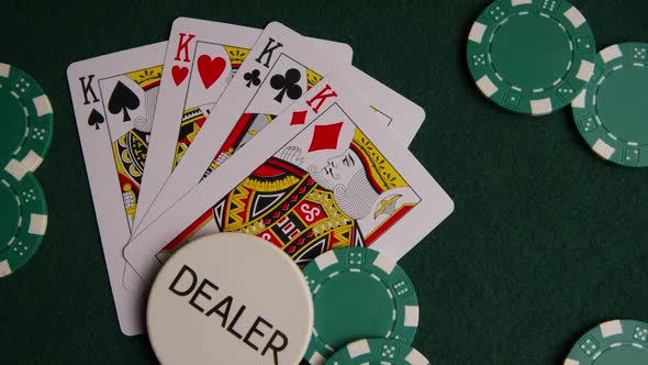 Rotating shot of poker cards and poker chips on a green felt surface - POKER 011 alt