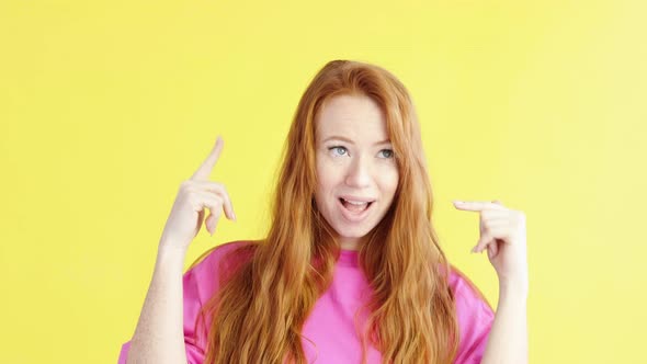 woman is dancing on an yellow background and twirling fingers near her head.
