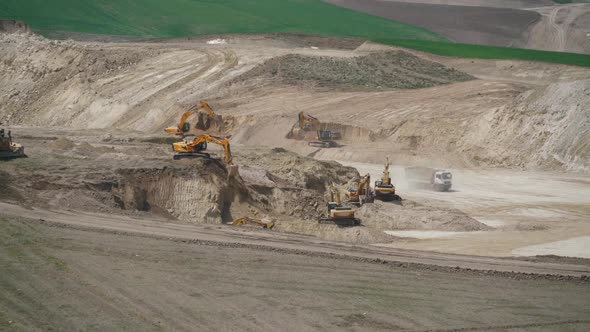 Excavation Machines and Dump Trucks are Working on Rural Countryside