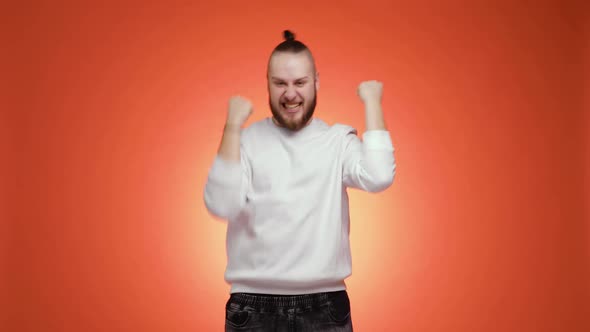 Overjoyed Young Bearded Man Is Doing Winner Gesture Saying Yes Funny Dancing