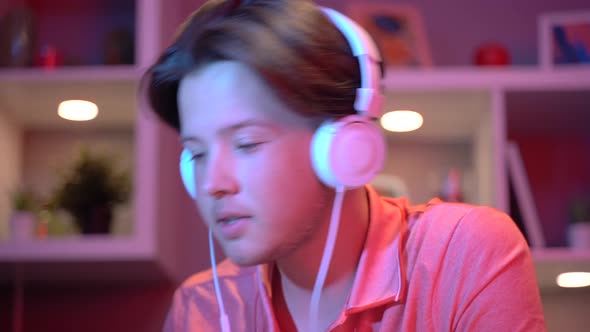 Young man listening to music at home. alt