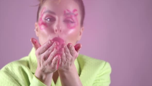 Young Beautiful Woman Professional Make Up Artist with Lipstick Marks Smile at Pink Background alt