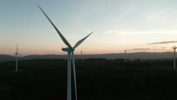 Wind Turbines Slowly Turning During Colorful Sunset At Nature Landscape In Serra de Aire