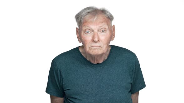 Portrait of Displeased Old Aged Man 80s Having Gray Hair in Basic Tshirt Staring at you with alt
