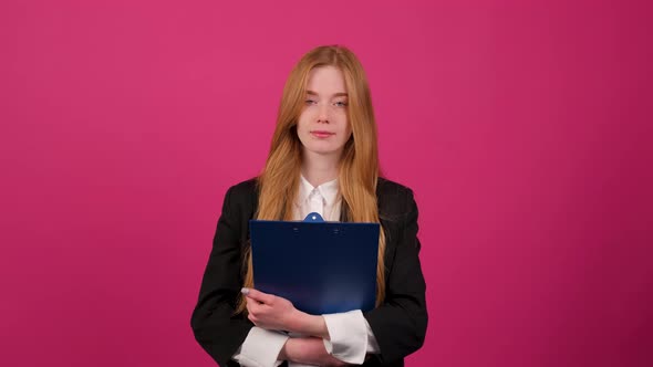 Portrait of Young Businesswoman Holding a Folder Isolated on Pink Background alt