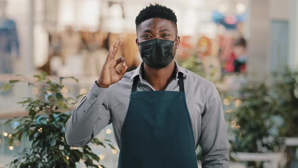 Young African American Male Restaurant Worker Barista Salesman in Apron Cafe Waiter Standing in alt