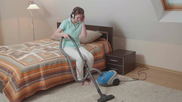 Cute Caucasian girl cleaning her house with sadness. alt