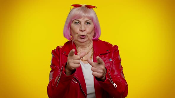 Senior Old Granny Woman Pointing Around with Finger Gun Gesture Shooting Killing with Hand Pistol alt