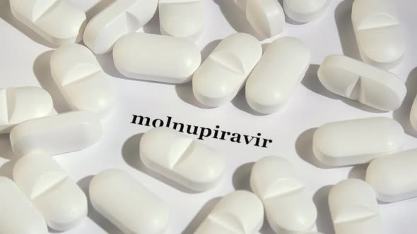 Closeup Shot of White Tablets on White Background with Black Text alt