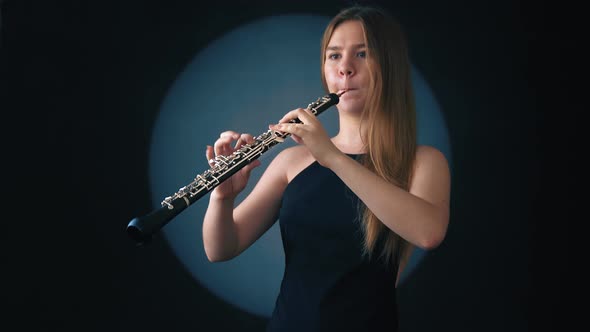 Musician Girl Playing an Oboe