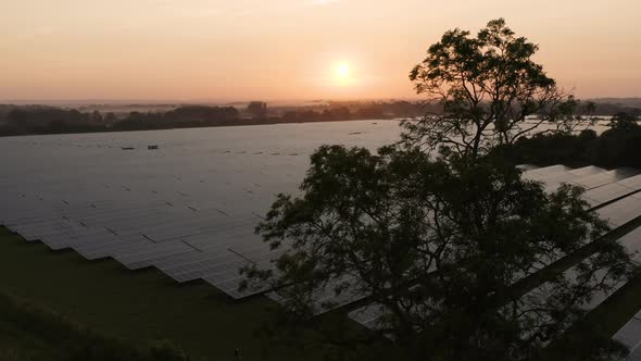 Aerial view over solar farm at sunrise