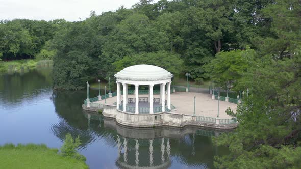 Bandstand With Reflection On Water At Roger Williams Park In Providence, Rhode Island, USA. - aerial alt
