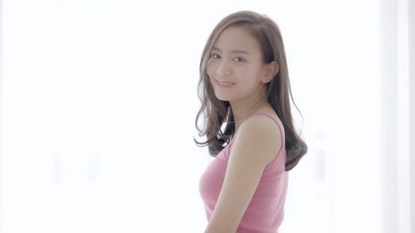 Beautiful portrait young asian woman with smiling and laughing in bedroom. alt