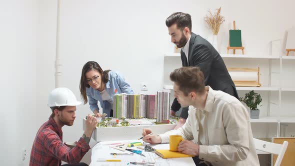 Clever Ambitious Architects Brainstorming at Meeting. alt