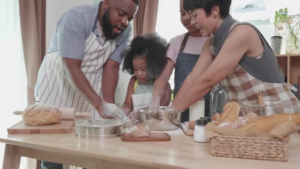 African America family enjoy threshing flour for cooking or bread together in a weekend alt