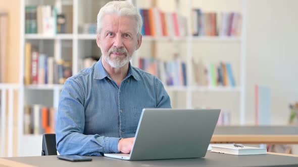 Positive Old Man with Laptop Doing Thumbs Up alt