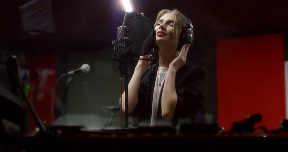 Beautiful Woman Sings a Love Song in Recording Studio alt