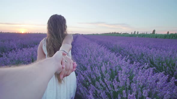 Girl Walks Among Lavender Holding Boy By the Hand alt