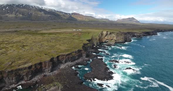 Lava cliffs at Snaefellsnes, Iceland, Snaefellsjokull volcano in the back alt