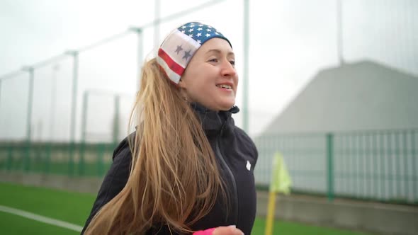 Portrait of woman in sportswear doing jogging at the stadium alt