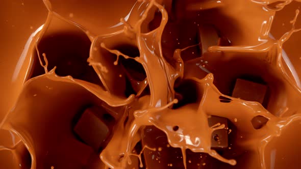 Super Slow Motion Shot of Caramel Chunks Falling Into Melted Caramel at 1000Fps alt