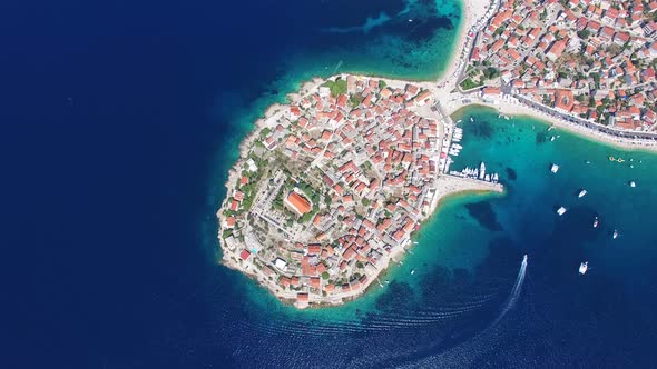 Aerial view of speedboat passing Primosten peninsula, Croatia alt