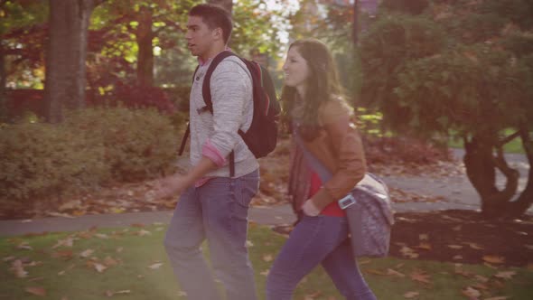 College students on campus walk to meet group