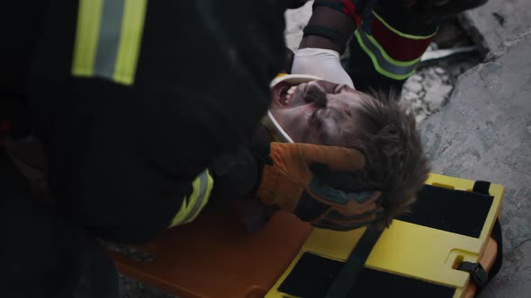 Emergency Service Workers Putting Teenager on Spinal Board alt