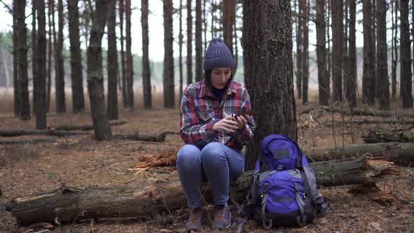 Lost Tourist Woman Uses Golden Survival Blanket in Forest alt