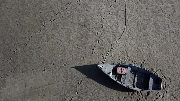 Top View of Boat at the Shore of Dried Up Sea Global Warming and Drought Concept alt