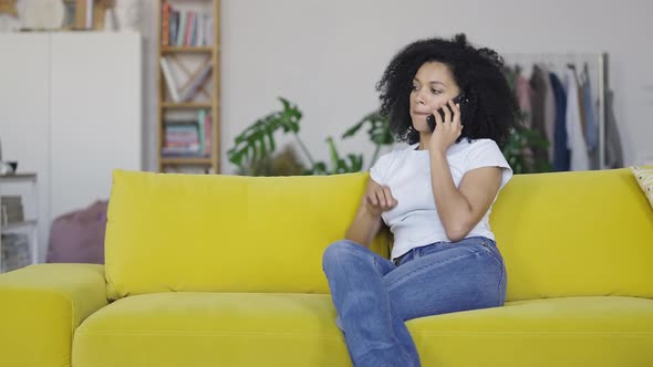 Portrait of a Young African American Woman Talking for Mobile Phone alt